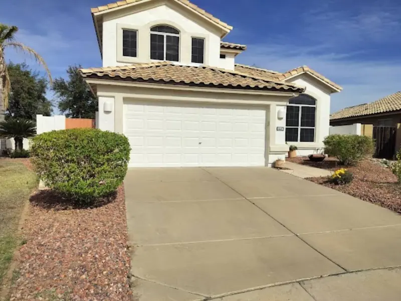 Trimmed shrubs and maintained front yard by Arrowscape