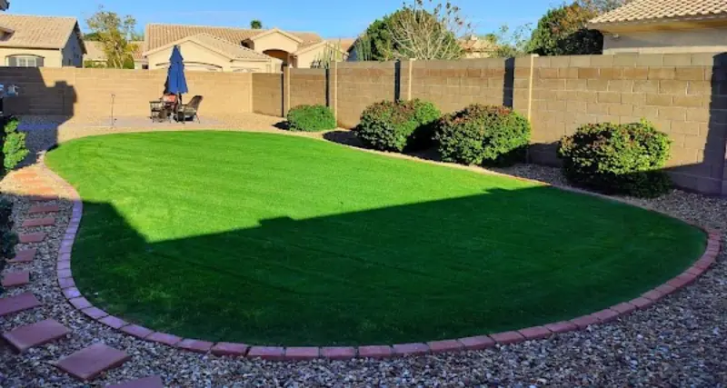 Freshly maintained backyard lawn and shrubs by Arrowscape